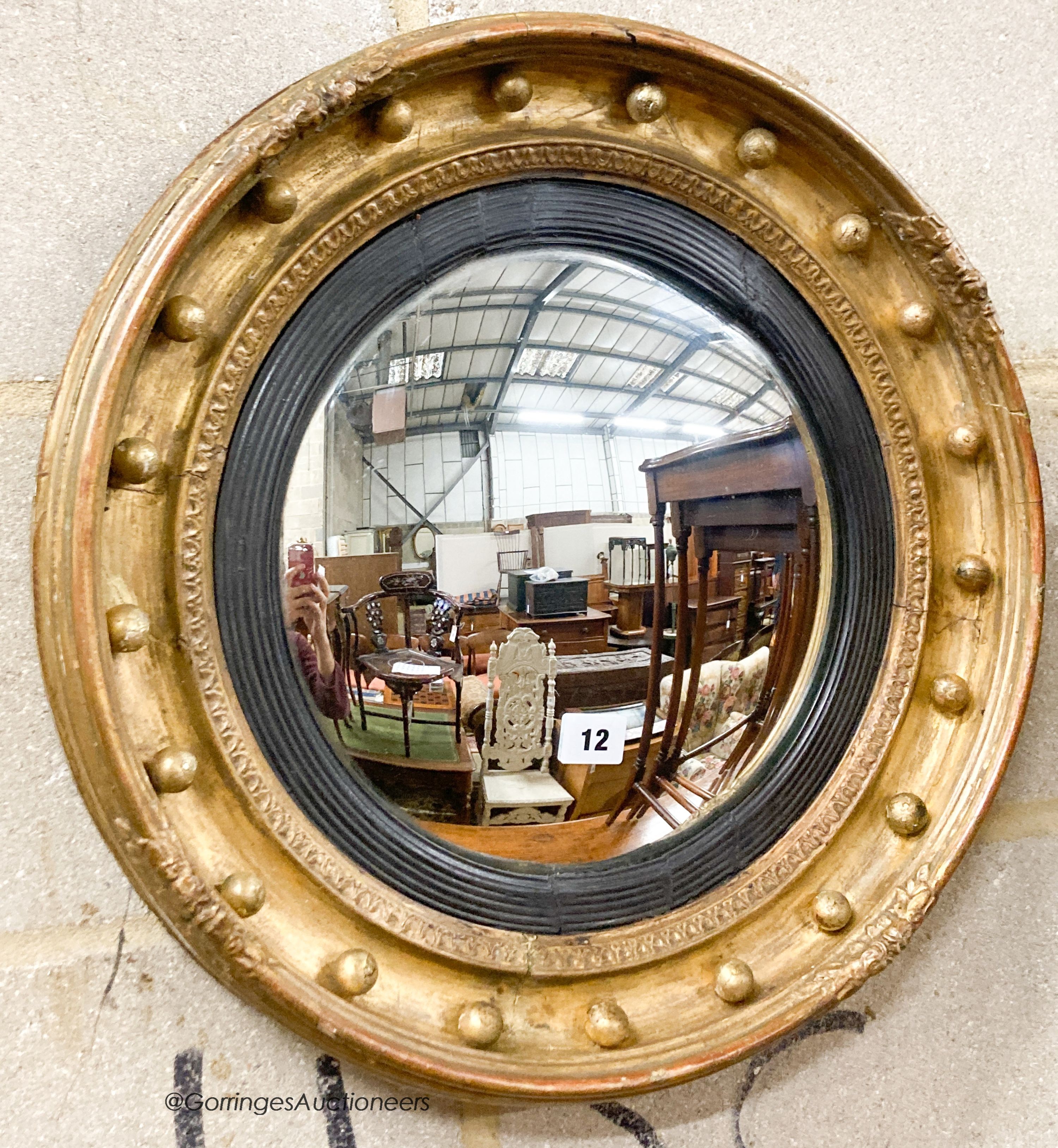 A Victorian giltwood and gesso convex wall mirror, diameter 47cm